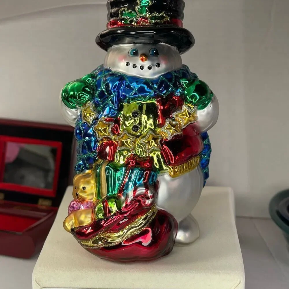 Charming hand-blown mercury glass snowman candle holder.